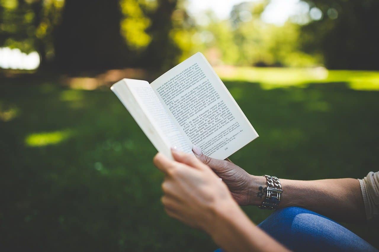 Reading a book, gook in a park